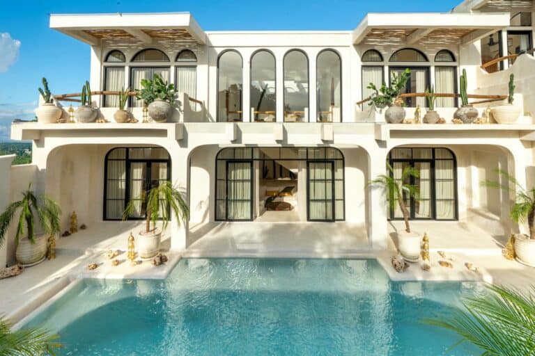 Modern villa with swimming pool and potted plants.