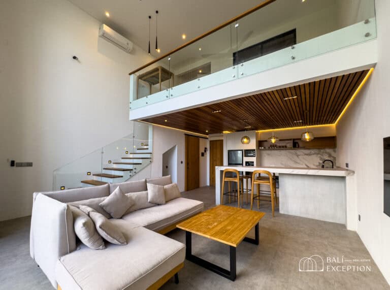 Modern open-concept living room with kitchen and mezzanine.