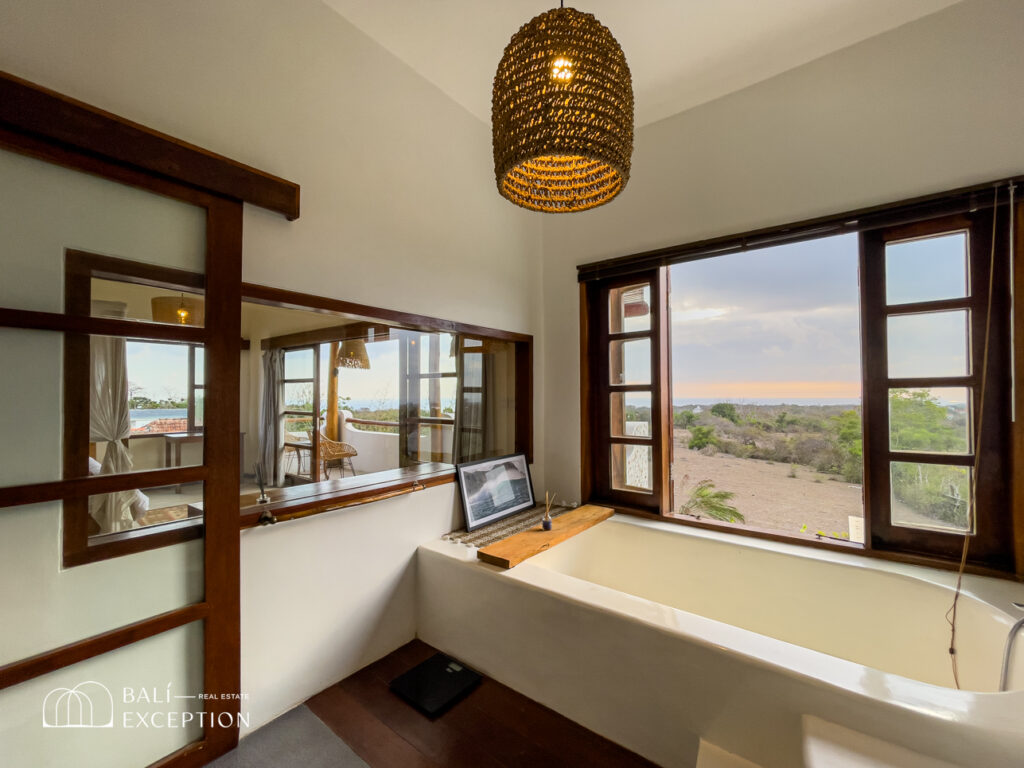 Bathroom with tub and scenic window view