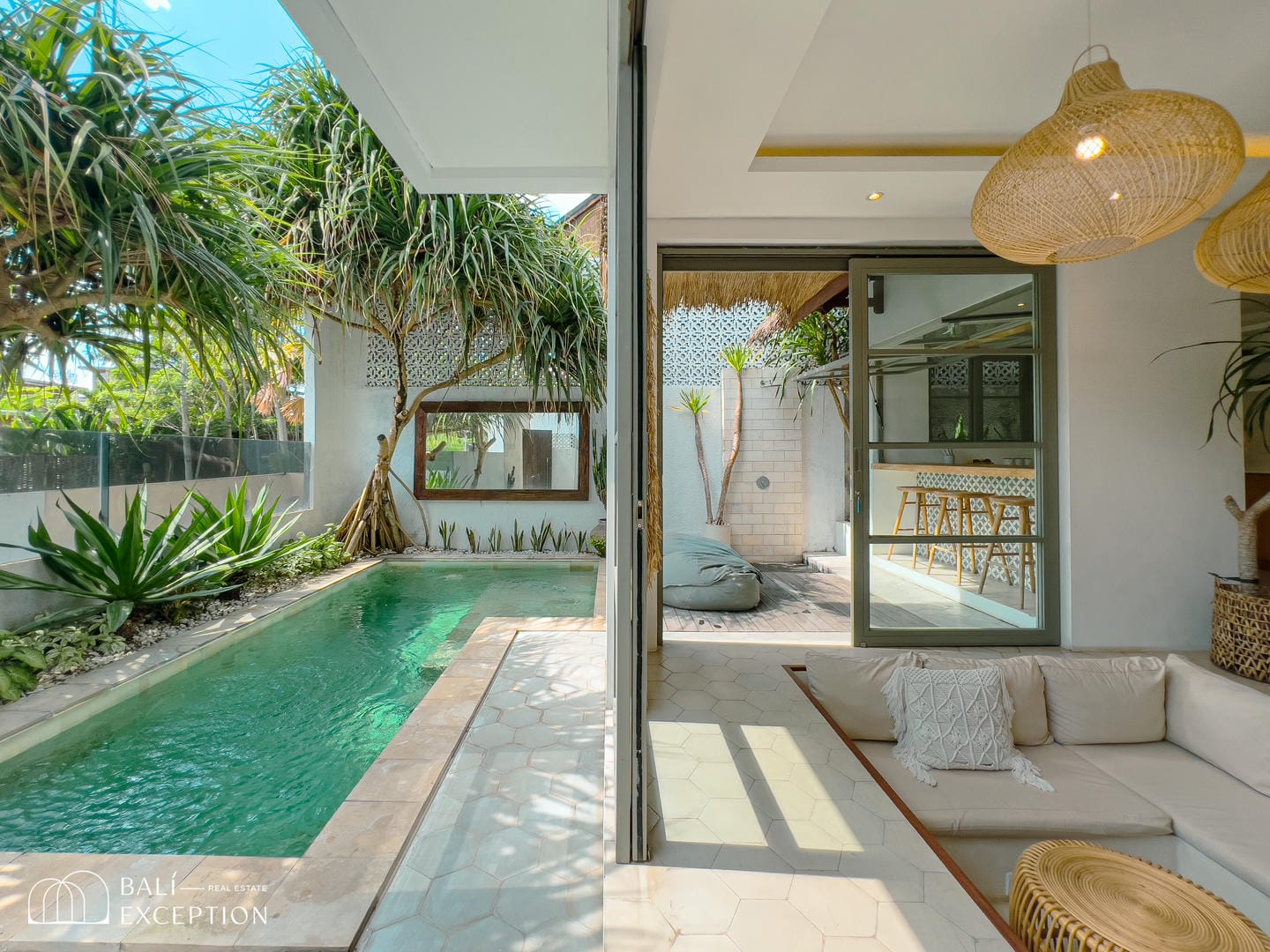 Modern villa with pool and outdoor lounge area.