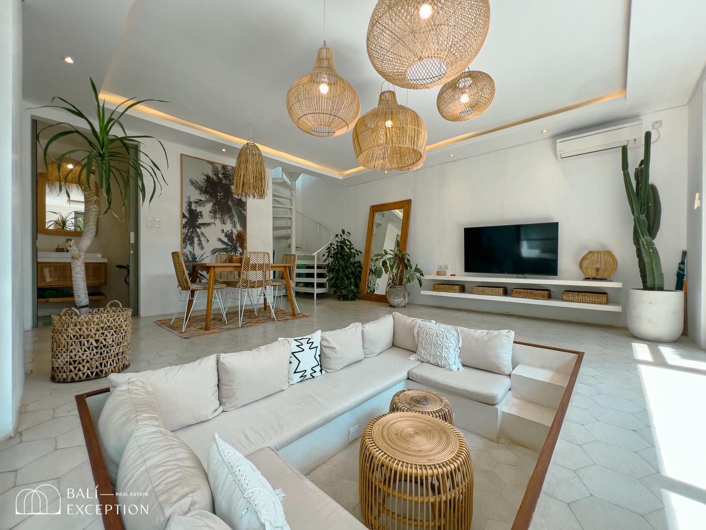 Modern living room with wicker furniture and decor.