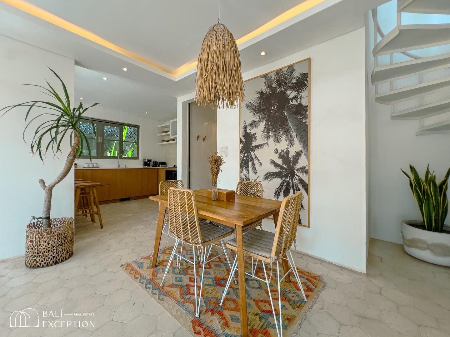 Modern kitchen and dining area with palm decor