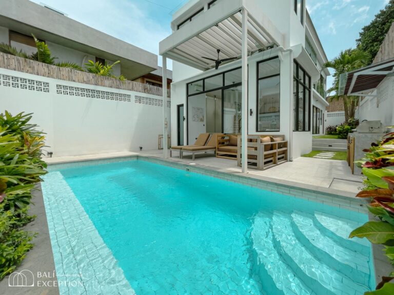 Modern villa with swimming pool and lush greenery.