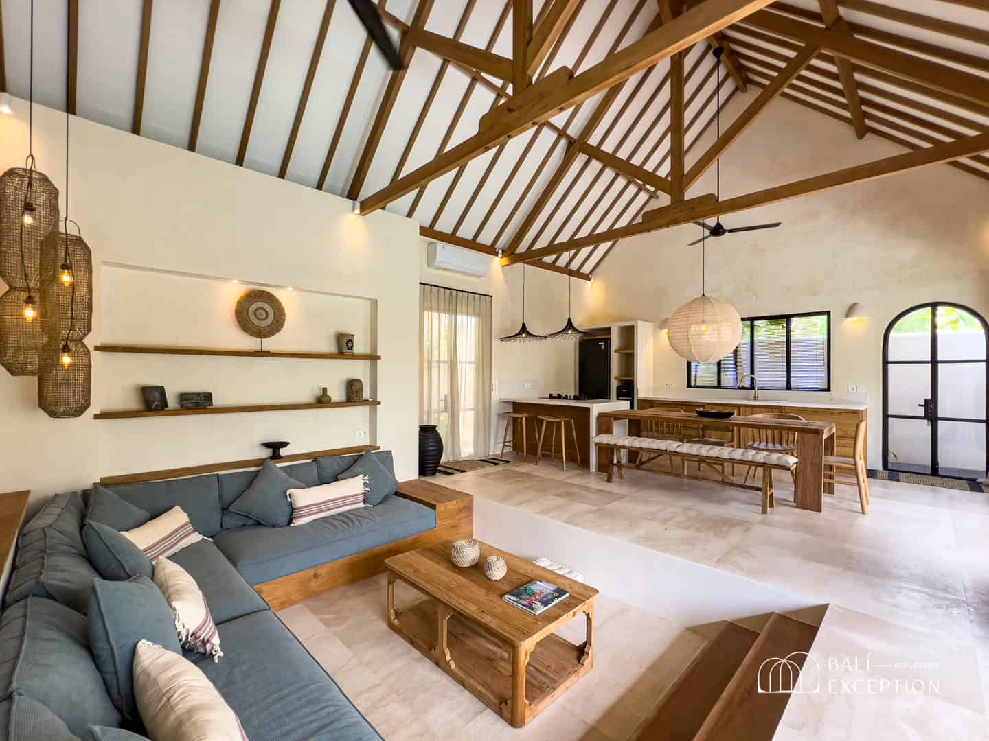 Spacious living room with wooden ceiling and furniture.