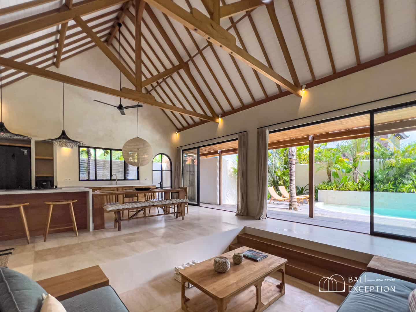 Luxurious open living area with pool view.