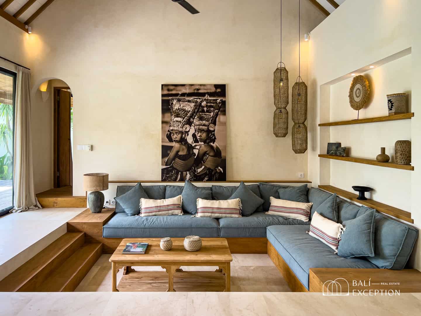 Modern living room with blue sofa and art decor.