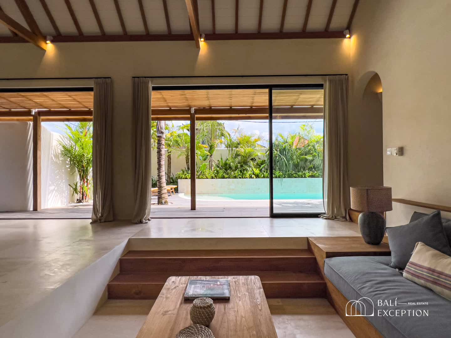 Modern living room with pool view and patio.