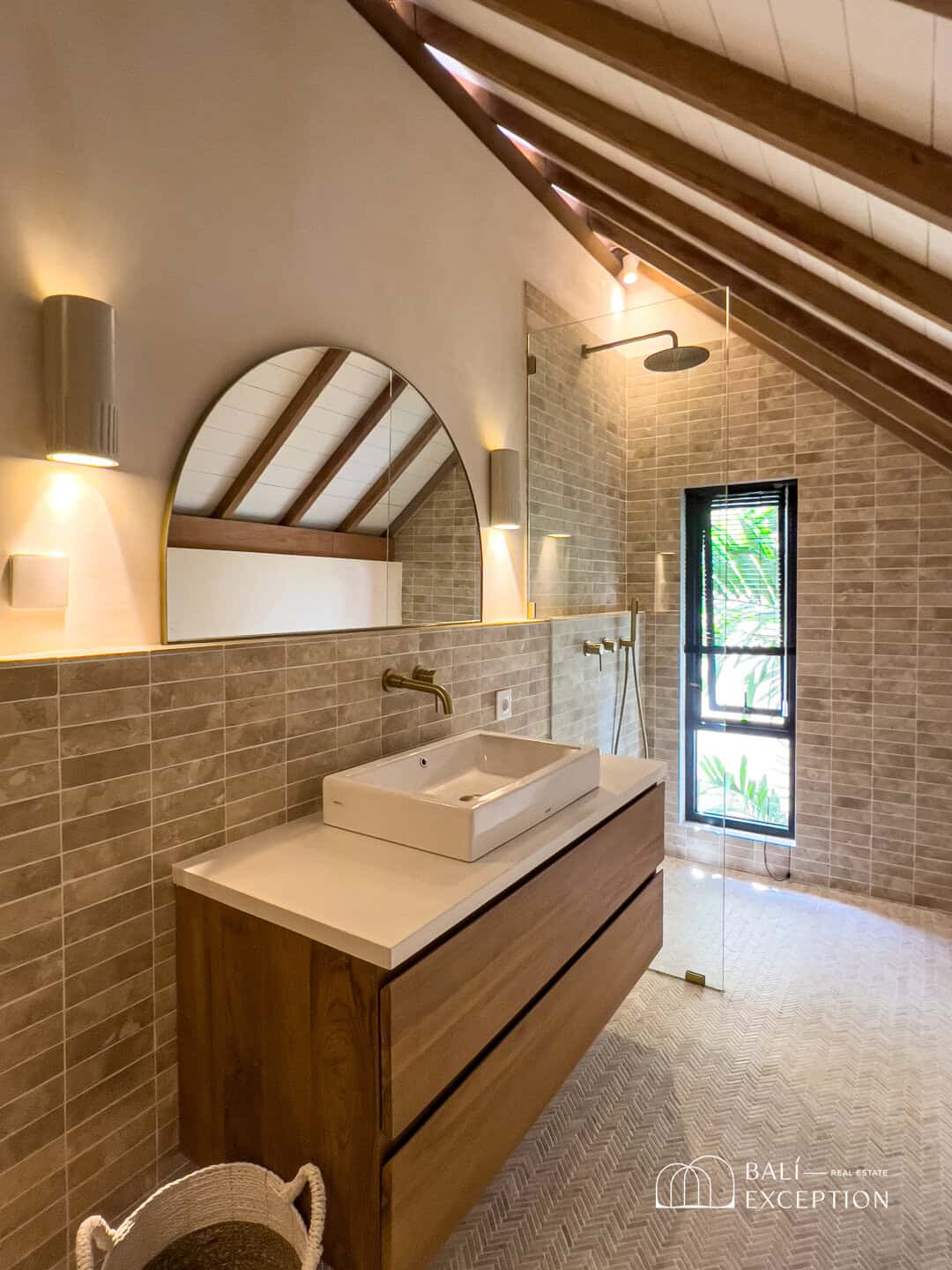 Modern bathroom with wooden vanity and rainfall shower.