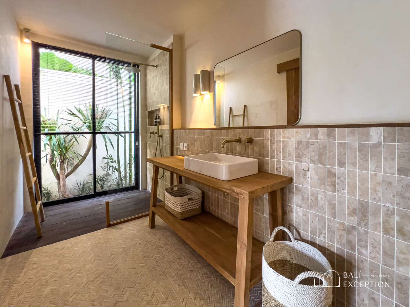 Modern bathroom with wooden sink, mirror, and shower.