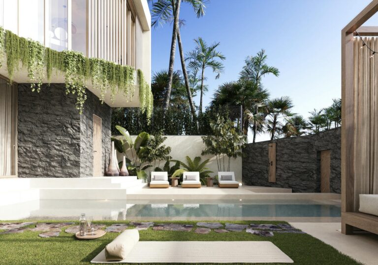 Luxury villa patio with pool and greenery.