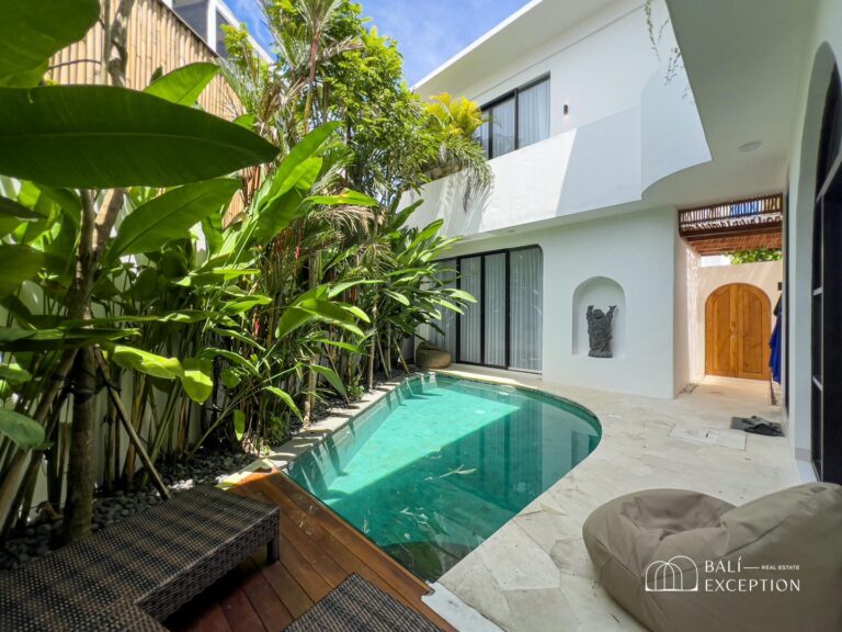 Modern villa with lush garden and private pool.