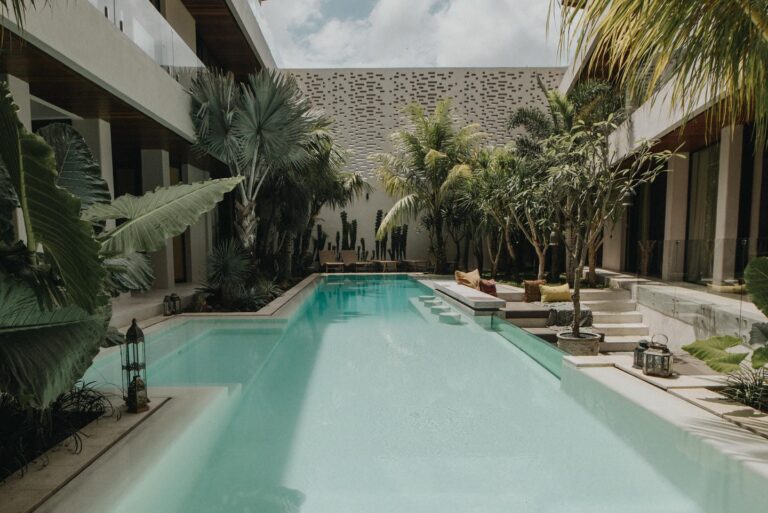 Luxurious courtyard pool surrounded by tropical plants.