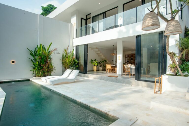Modern villa with pool and outdoor seating area.