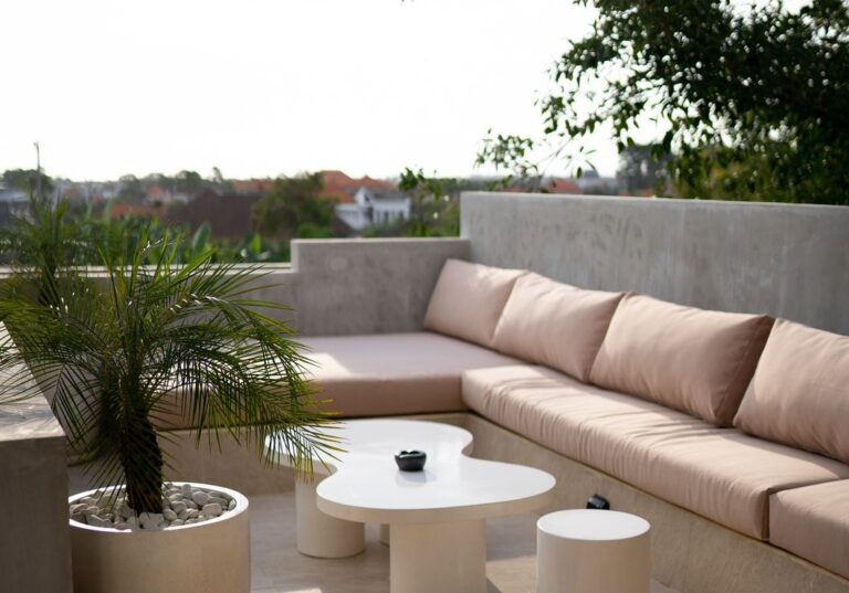 Modern outdoor patio with beige seating and table.