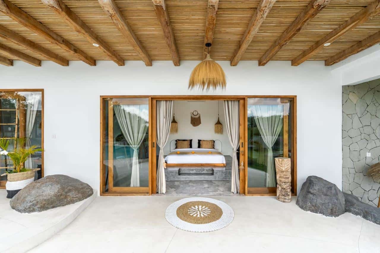 Eco-friendly bedroom with rustic decor and patio doors.