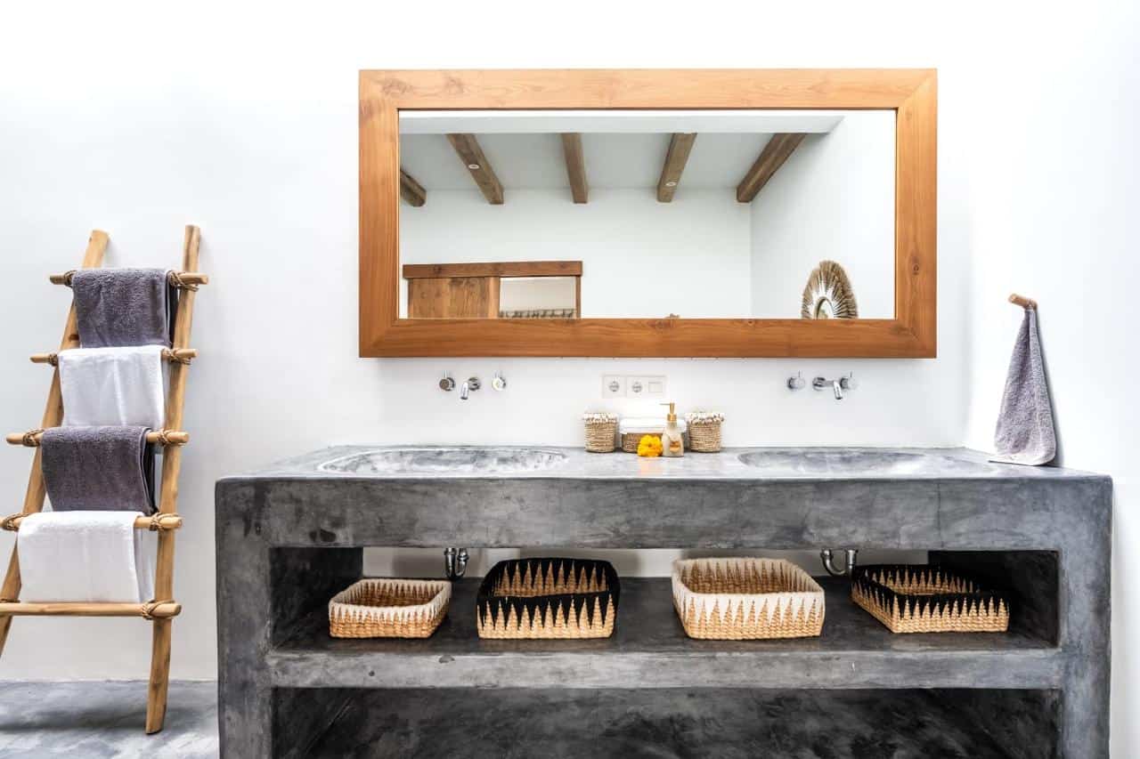 Modern bathroom with mirror and ladder towel rack.