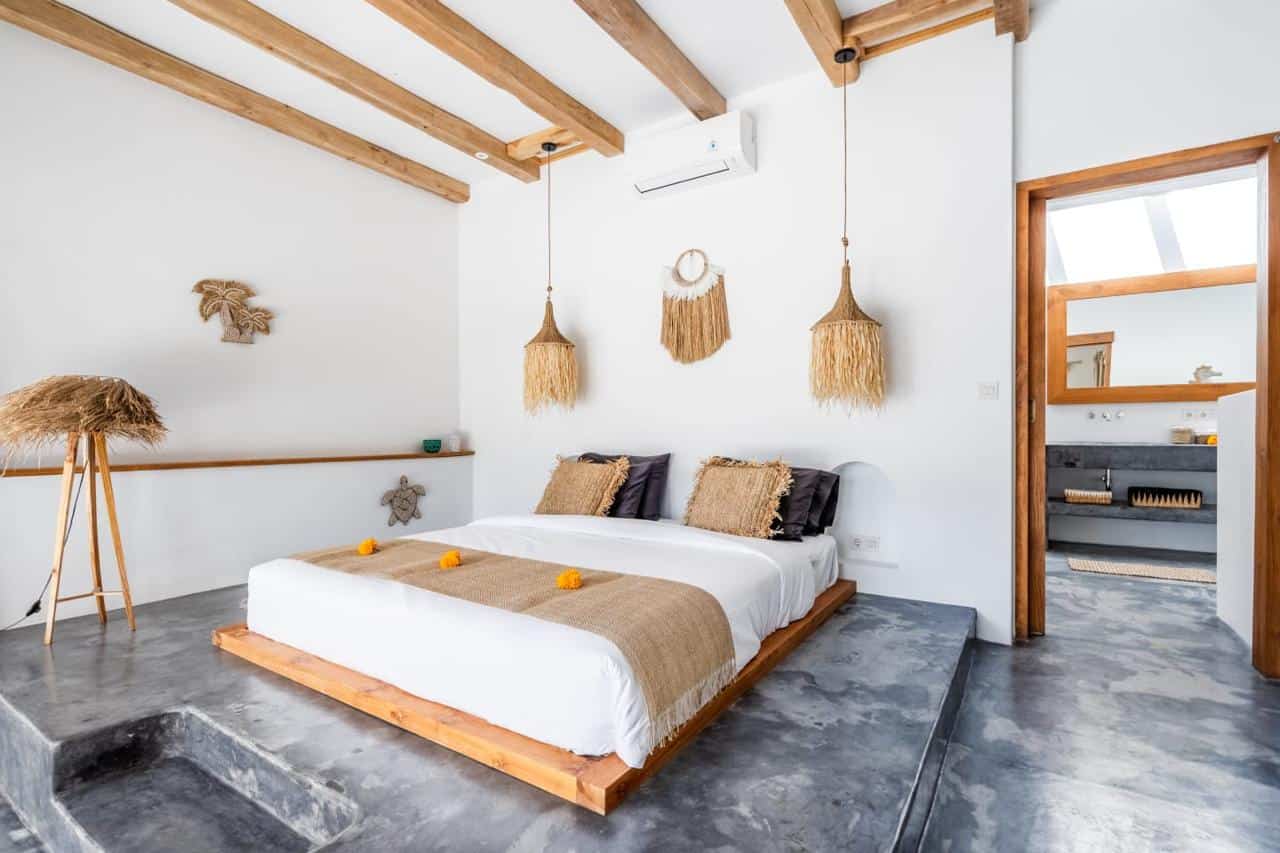 Modern bedroom with natural decor and concrete floor