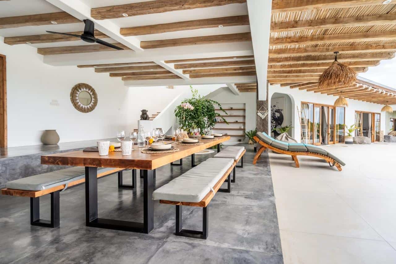 Spacious modern dining area with wooden table.