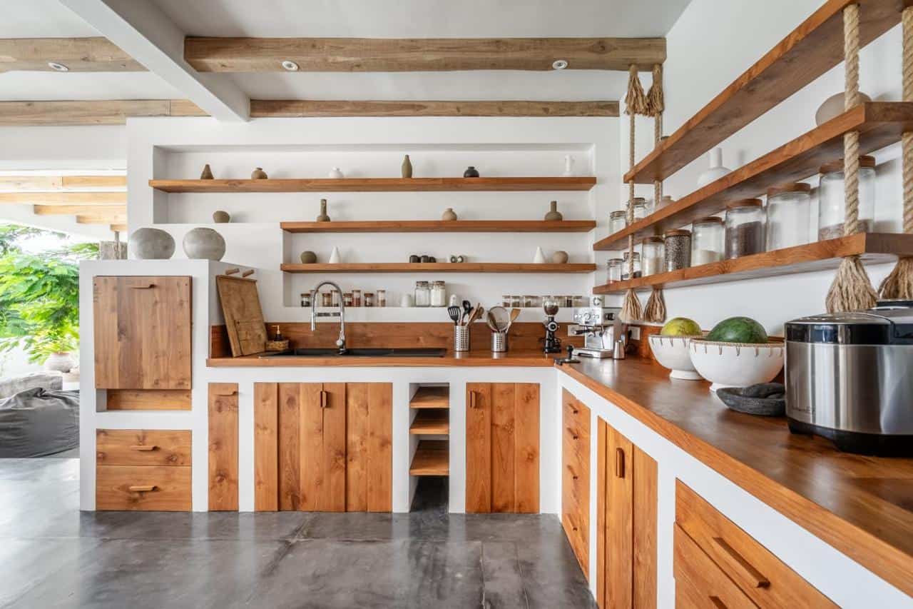 Modern kitchen with wooden shelves and appliances.