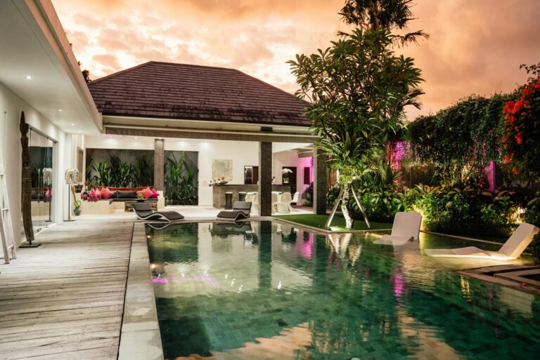 Luxurious villa with pool at sunset.