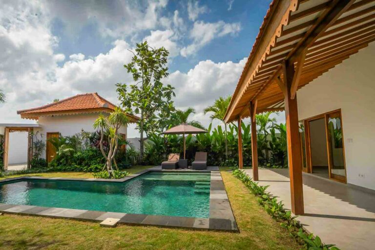 Tropical villa with pool and garden view.