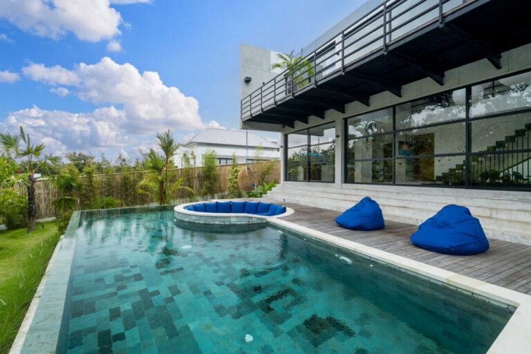 Modern house with pool and outdoor seating.