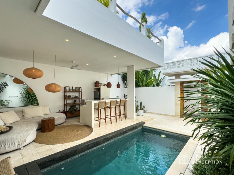 Modern patio with pool and bar seating.