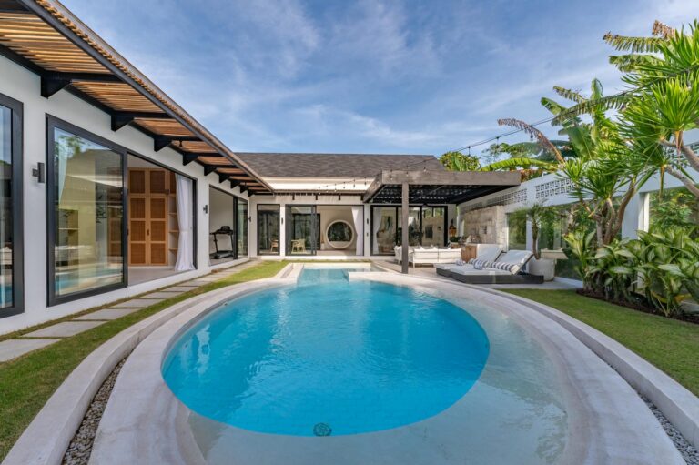 Modern home with pool and patio area.
