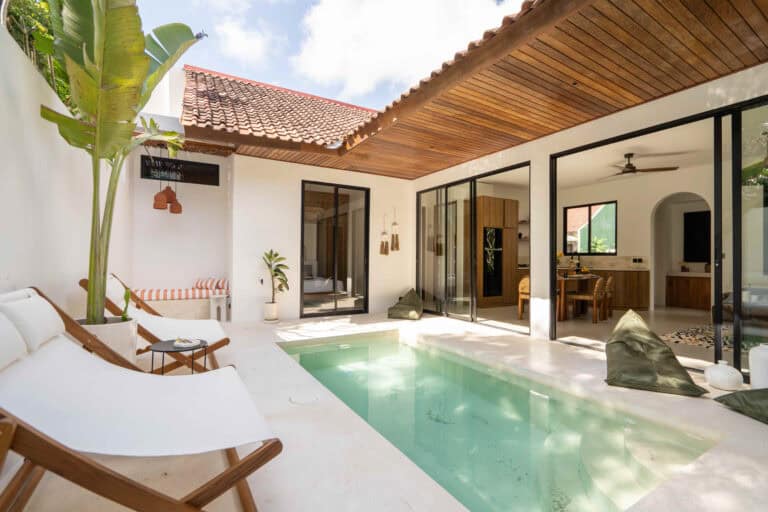 Luxurious tropical villa with pool and outdoor seating.