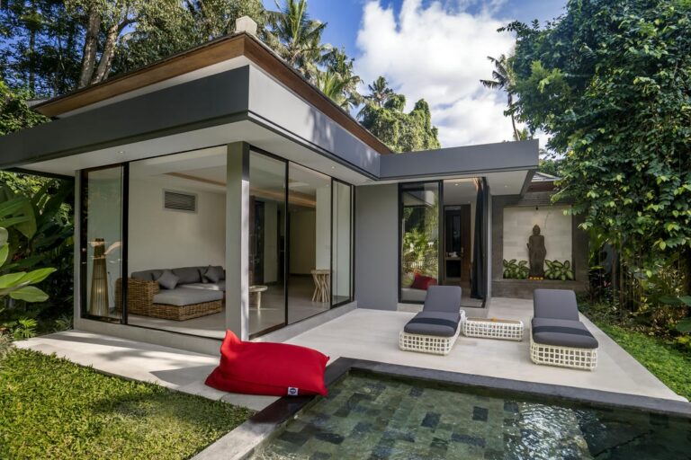 Modern villa with pool and outdoor lounge area.