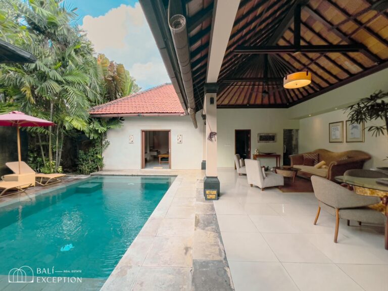 Tropical villa with pool and open living area.