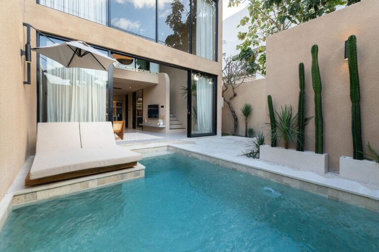 Modern house with pool and patio lounge.