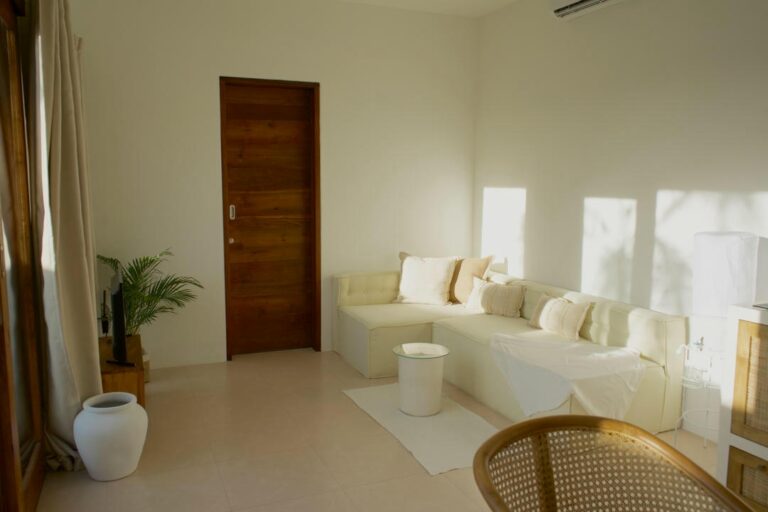 Minimalist living room with white sectional sofa.