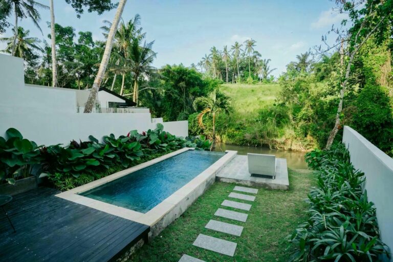 Tropical villa with pool and garden view.