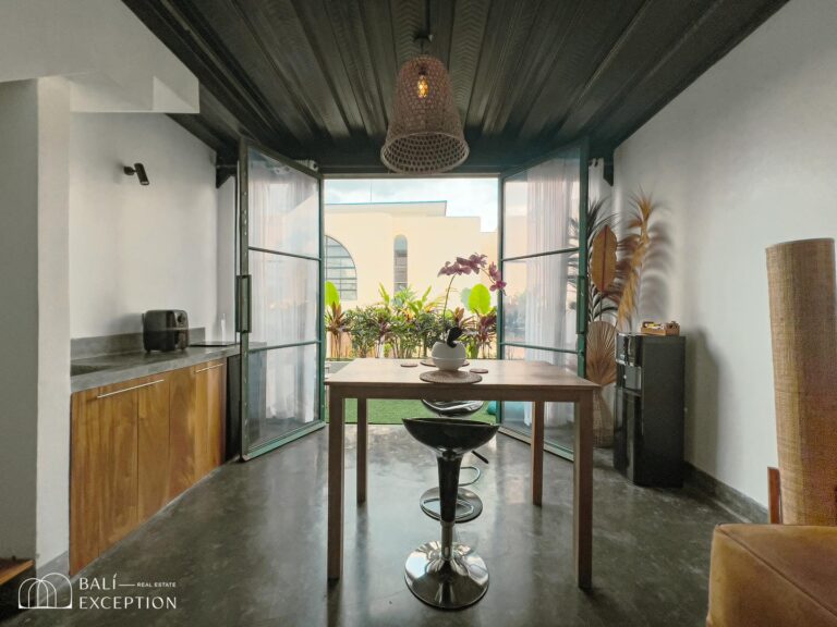 Modern dining area with open garden view.