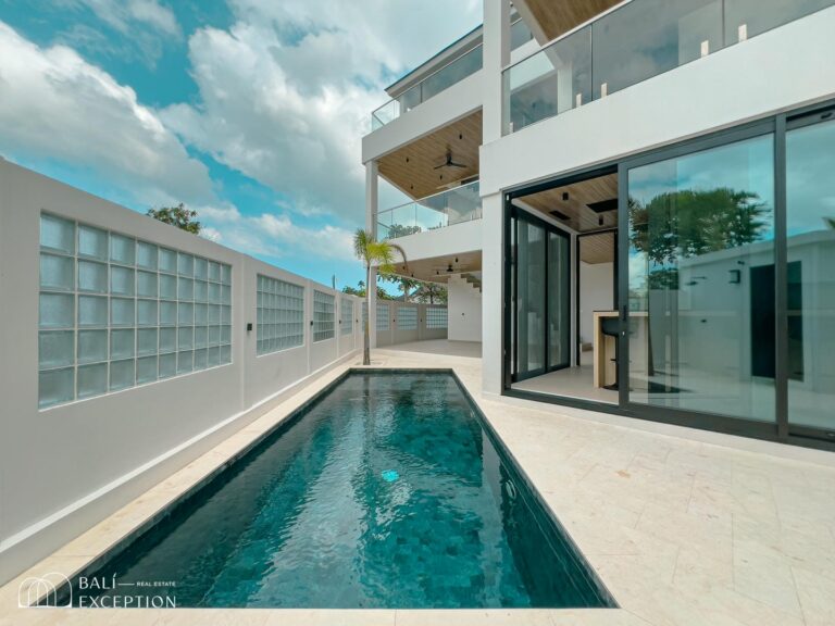 Modern villa with pool and glass walls.