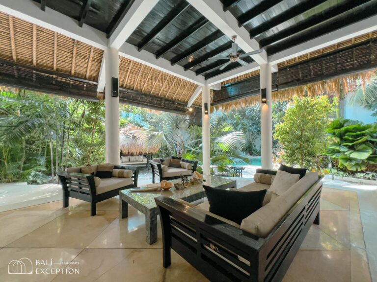 Luxurious outdoor seating area with garden view.